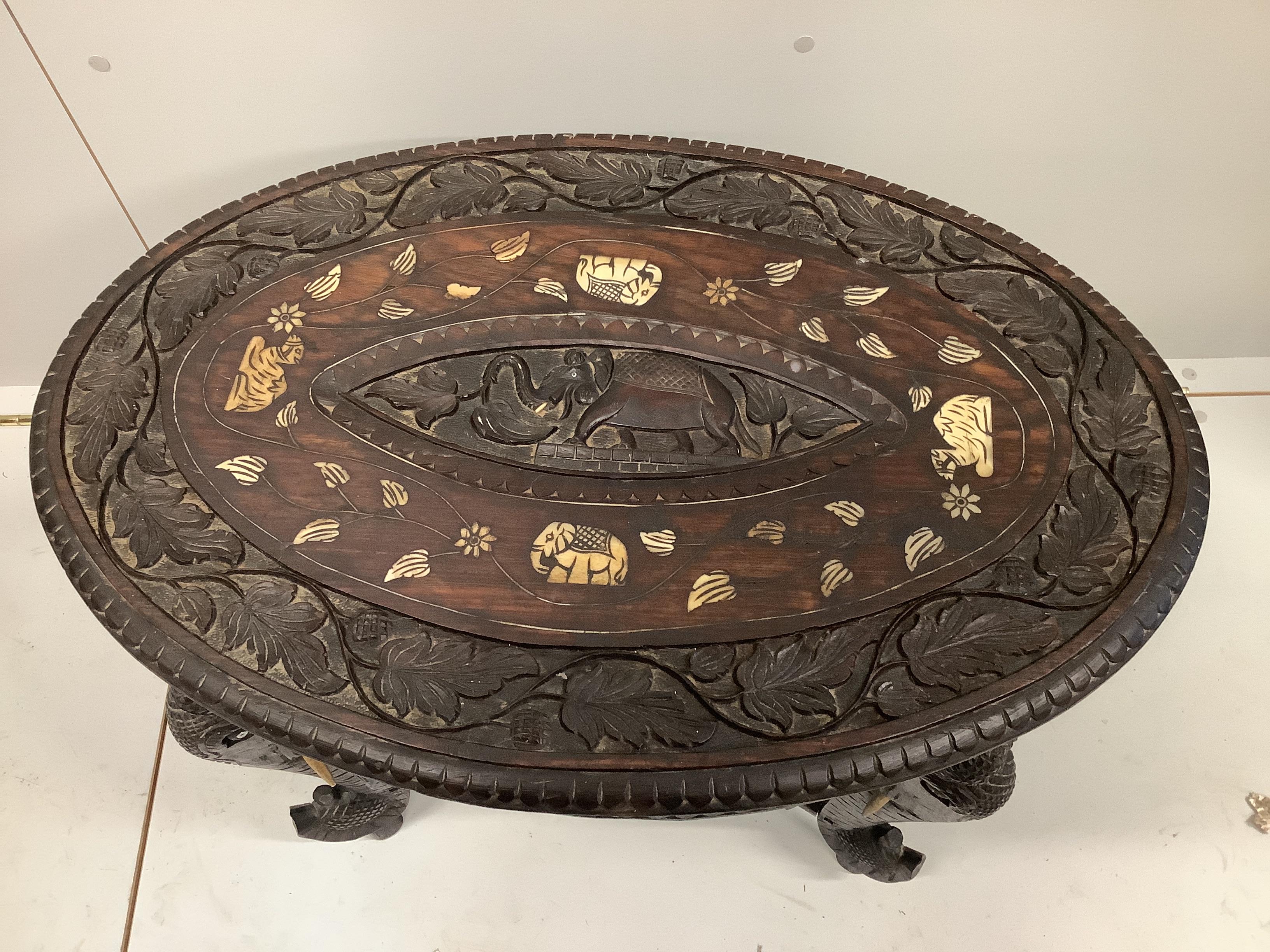 An oval Indian bone inlaid carved hardwood occasional table, width 68cm, depth 46cm, height 52cm